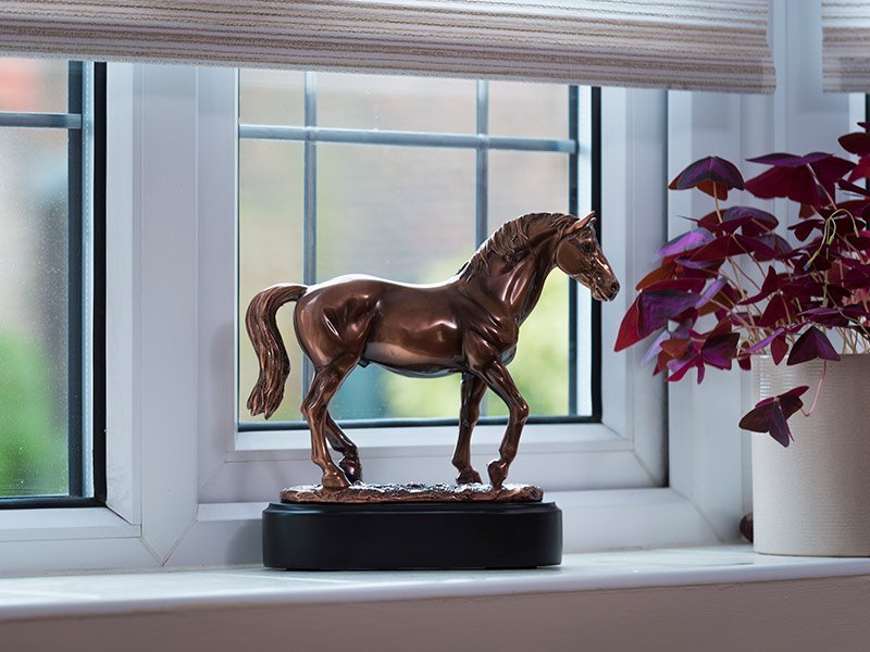 CHAMPION Our lovely figurine ashes keepsake urns are so discreet and look lovely in any setting. Sculptured ornamental ashes urns caskets.